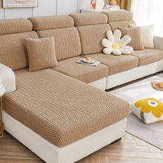 a living room filled with lots of furniture next to a large flower on the wall