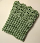 a green crocheted mitt sitting on top of a table