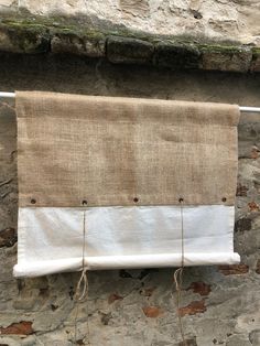 a burlocked curtain hanging on a stone wall