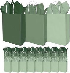 green paper bags with handles are lined up against each other