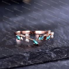 two gold rings with turquoise stones and diamonds on a black surface in front of the camera