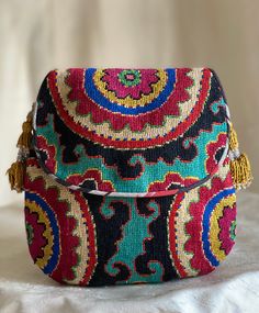 "Smallish size Flat with Flap Silk Petit Point Handbag created and handmade in Uzbekistan. Lined with silk and cotton stripe fabric, hand woven silk straps and tassels with a magnetic snap closure. Each handbag is hand drawn onto cotton canvas, inspired by original designs from Uzbekistan textile history.  8\" high x 7.5\" width, top opening 6\" wide approx. 60\" strap x 3/8\" width.  Can fit largest sizes of iPhone and Android. 100% silk petit point with handwoven silk ikat lining. I can shorte Traditional Multicolor Shoulder Bag With Removable Pouch, Traditional Multicolor Bag With Removable Pouch, Traditional Festival Bag With Removable Pouch, Traditional Multicolor Bags With Removable Pouch, Multicolor Handwork Pouch Shoulder Bag, Artisan Multicolor Shoulder Bag With Removable Pouch, Artisan Multicolor Bag With Removable Pouch, Artisan Multicolor Bags With Removable Pouch, Traditional Pouch Bag With Multicolor Embroidery