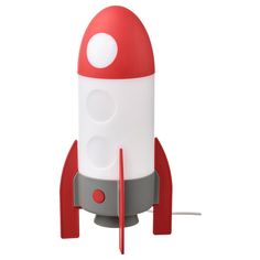 a red and white rocket ship shaped lamp