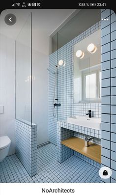 a bathroom with blue and white tiles on the walls