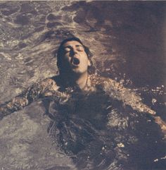 a man swimming in the water with his mouth open