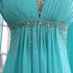 a blue dress with silver beads on it