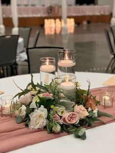 a table with candles and flowers on it