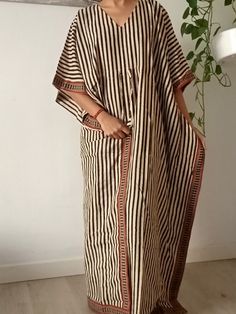 This Item is handmade. We use organic top quality cotton to ensure your skin is pampered and always natural. It is beautifully painted on with blocks- a traditional Indian style of printing.Each layered block by block,colour by colour, creating an exquisite design. The dyes used are also organic. The design is multi functional depending on your mood, Use it like a kaftan to lounge around the house in or even as a swim cover up for your day at the beach or pool. The second item and consecutive it Bohemian Striped Long Sleeve Kaftan, Traditional Thobe With Kimono Sleeves For Beach, Striped Long Sleeve Bohemian Kaftan, Striped Cotton Maxi Dress For Vacation, Bohemian Striped Kaftan For Summer, Bohemian Striped Kaftan For Beach Cover-up, Striped Cotton Bohemian Dress, Bohemian Striped Cotton Dress, Striped Long Sleeve Kaftan For Vacation