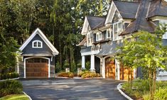 a large house with two garages on each side