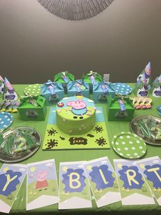 a birthday party with pep the pig cake and decorations on a green table cloth covered table