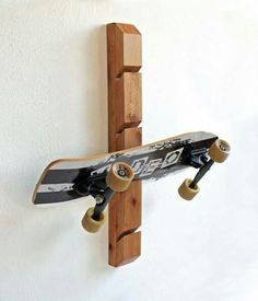 a skateboard mounted to the side of a wall with two wheels on each end