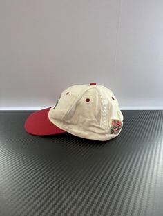 Very Good - Excellent quality. May have very minor imperfections that may or not be visible to the eye. Minor use. This vintage cap features the iconic T-Rex from Universal Studios Parks. With a red bill and white cap, it adds a touch of nostalgia to any outfit. Show your love for the parks with this unique and stylish accessory. FEATURES Retro Red Hats For Baseball Season, Red Retro Hats For Baseball Season, Red Retro Hat For Baseball Season, Retro Red Fitted Hat For Baseball Season, Red Retro Fitted Hat For Baseball Season, Retro Red Baseball Cap For Outdoor, Vintage Red Snapback Hat For Outdoor, Vintage Red Baseball Cap For Sports, Vintage Red Flat Bill Baseball Cap