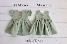 2-3 WEEK TURNAROUND TIME. This light green, seafoam cotton/linen handmade dress is the perfect addition to any little's wardrobe! Though great for all year cuteness! Perfect fall and winter with elbow length sleeves. Or summertime fun with the tank version. Dress is a elbow-sleeved or sleeveless, with a lined, slightly curved front bodice. Three wooden button closures in the back of the dress of the 3/4 sleeved version. Tank version has a V-back and 1 button. This fabric is a linen cotton blend, Green Buttoned Dress For The Beach, Cute Button-up Summer Dresses, Cute Summer Button-up Dresses, Green Buttoned Dress For Beach, Green Buttoned Beach Dress, Cute Fitted Button-up Dress, Green V-neck Dress With Buttons, Cute Cotton Button-up Dress, Cute Button-up Cotton Dresses