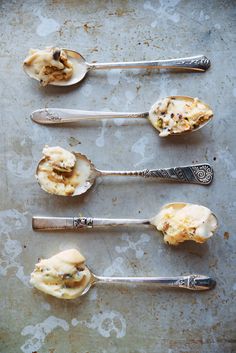 four spoons with different types of food on them