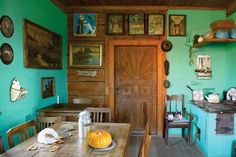 an old fashioned kitchen with blue walls and pictures on the wall