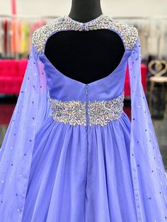 The Samantha Blake 1023 Girls Long Cape Sleeve Pageant Dress is perfect for any special occasion. The crystal cut out back and A line silhouette add a touch of elegance to the chiffon material. With long cape sleeves flowing from a cap sleeve, your child will feel like a true princess in this beautiful dress. Perfect Unique look for Pageants! Sizes: 2-16 Colors: Periwinkle Chiffon Party Dress With Back Zipper, Party Dress With Back Zipper In Chiffon, Chiffon Homecoming Dress With Sweep Train, Purple Georgette Evening Dress, Party Gown With Fitted Bodice In Georgette, Embellished Georgette Evening Dress For Prom, Fitted Georgette Prom Gown, Dress Crystal, Long Cape