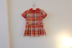 "1960's Vintage Girls Cotton/Poly Red Green Blue Plaid Mod Aline Shift Dress Dropped Waist Pleated Full Skirt Short Sleeve Flat Collar-size S label--JCPenney red flat rounded collar with white piping  *  zipper closure back of bodice metal hook and eye top of zipper  *  short sleeves with folded cuffs  *  dropped waist   *  full pleated skirt no belt  *  no lining  *no pockets modern size S Soft, mediumweight cotton/poly fabric--woven, no stretch!! Measurements Flat: Dress 12.5\" back shoulder 14.5\" across chest at bottom of armhole 15\" waist flat 15\" hip 3.25\" hem 23.75\" total length top shoulder front to hem Hand washed and hung dry and ready to wear! Excellent condition! Spots front skirt, right side seam coming undone,  Please check out all of my fabulous ETSY items on Lulavintage Retro Short Sleeve School Dresses, Retro Fitted School Dress, Retro Fitted Dress For School, Retro Cotton School Dress, Red Short Sleeve School Dress, Zipper Shorts, Skirt Short, Aline Dress, Dropwaist Dress