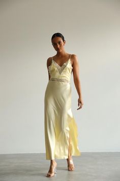 This long white Slip Dress made of soft pure mulberry silk. A V-neckline with lace, open back with adjustable spaghetti straps, meet a bias cut to fall beautifully against the body, inspiring a feminine silhouette. Effortless for both day and night, for romantic evening or as a bridal getting ready dress.   Model is 168 cm, 84/64/89 wears size XS Total length 135 cm from the shoulder  Off white color Chic V-neck Slip Dress For Wedding Night, Fitted V-neck Slip Dress With Lace Bodice, Chic Wedding Slip Dress With Lace Back, Fitted V-neck Slip Dress With Delicate Lace, Elegant V-neck Slip Dress With Lace Back, Chic Slip Dress With Spaghetti Straps And Boning, Chic Night Slip Dress With Bias Cut, Chic Lace Slip Dress With Lace Back, Wedding Dresses With Spaghetti Straps And Boning