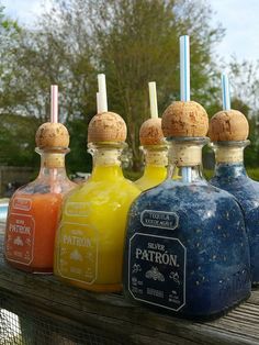 four bottles with different colored liquids in them