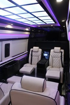 the interior of a luxury vehicle with white leather seats and black trim on the walls