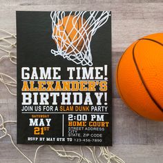 an orange basketball next to a black and white birthday card with the words game time on it