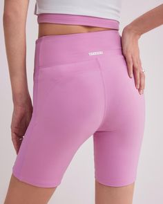 DETAILS: Color: Bubble gum pink High waist biker shorts with side contrast fabric Super soft & delicate brushed body fabric Medium weight 2x2 ribbed fabric on side panel Rubberized brand logo detail at back waist Body: 77% Nylon, 23% Spandex Contrast fabric: 93% Polyester, 7% Spandex Machine wash SIZE & FIT: Fits true to size Waist: 10 3/4" Inseam: 7" Model is wearing a size S Fitted Pink Activewear With Built-in Shorts, Pink High-waisted Athletic Shorts With Built-in Shorts, Pink High Waist Athletic Shorts With Built-in Shorts, Stretch Athletic Shorts With Ribbed Waistband, Pink Stretch Short Bottoms, Pink Stretch Bottoms Shorts, Pink High Stretch Athletic Shorts, Pink High-stretch Athletic Shorts, Pink Activewear With Built-in Shorts