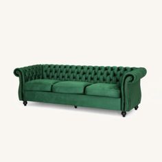 a green couch sitting on top of a white floor