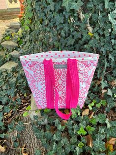 "This all purpose 9x11x6\" tote bag will carry your lunch to work in style.  Don't worry about spills, leaks or drips.  It's oilcloth so just wipe them away.  Just as with all my bags, this one is reversible.  I make the handles out of cotton and lightly pad them for comfort.  They are long enough to wear on the shoulder.  You will be getting this bag with a pink French toile print for the exterior and pink polka dots for the interior.   The handles are pink with pink dots.  The pocket is  pink Retro Pink Cotton Bag, Pink Tote Bag With Rolled Handles, Traditional Pink Tote Bag, Pink Floral Print Cotton Bag, Pink Graphic Print Tote Bag, Toile Print, My Bags, French Toile, Pink French