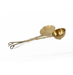 two metal spoons sitting on top of each other