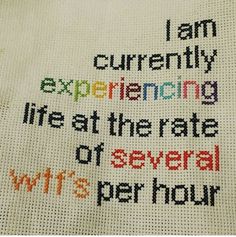 a cross stitch sample with the words i am currently experiencing life at the rate of several wit's per hour