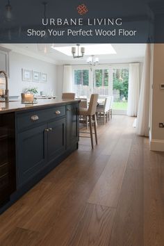 an open kitchen and dining room with wood flooring