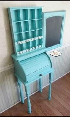 a small blue desk with a chalkboard on it