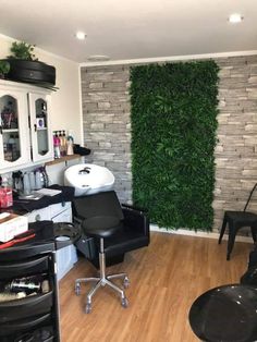 a hair salon with chairs and plants on the wall