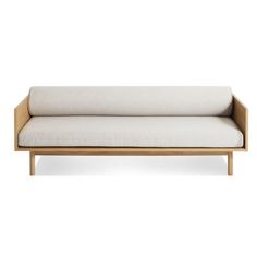 a white couch sitting on top of a wooden frame