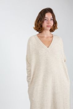 Brushed knit merino wool blend dress with side seam pockets and ribbing at v neck, hem, and cuffs.Lauren Manoogian Details Made in Peru. 63% Merino Wool 27% Alpaca 10% Lycra. Hand wash cold with mild soap and lay flat to dry. Do not bleach. Oversized Cream V-neck Sweater, Oversized Neutral V-neck Sweater, Cream Cashmere V-neck Sweater, Elegant Oversized V-neck Sweater, Beige V-neck Sweater With Ribbed Cuffs, Cream V-neck Sweater Dress For Fall, V-neck Merino Wool Sweater For Work, Workwear Merino Wool V-neck Sweater, Fall Cream V-neck Sweater Dress