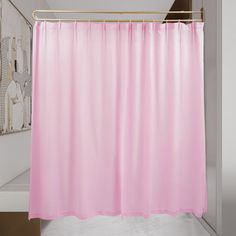 a pink shower curtain in a bathroom