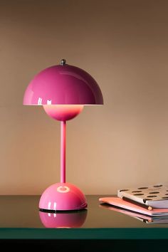 a pink lamp sitting on top of a table