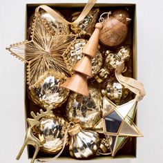 a box filled with gold and silver ornaments