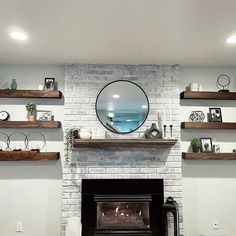 a living room with a fire place and shelves on either side of the fireplace,