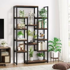 a living room filled with furniture and a flat screen tv on top of a wooden shelf