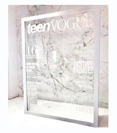 the front cover of teenvoguie magazine on display in a marbled room