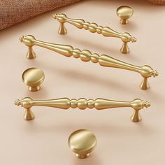 gold handles and knobs on a beige surface