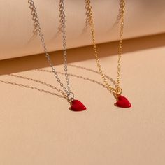 Let your big heart be showcased with our dainty Red Heart Necklace. The cherry red heart charm is minimalist and perfect for layering with any other chains in your collection. This charm necklace is a trendy yet everyday design to throw on and add brightness to a simple outfit. Material: High Quality Solid 925 Sterling Silver Finish: Sterling Silver ∙ 18K Gold Featuring a ~8 x 6mm Red Enamel Heart Charm with minimalist cable chain adjustable 16 inches to 18 inches SKU: RR-NR141 Aquamarine Stacking Ring, Red Heart Necklace, Duo Beads, Pearl Anklet, Simple Outfit, Beaded Anklets, Teardrop Necklace, Chain Anklet, Big Heart