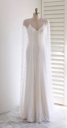 a white wedding dress on a mannequin