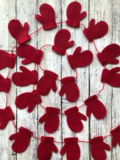 red felt hearts hanging from string on wooden surface