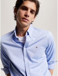 Tommy Hilfiger men's shirt. For work and the weekend, our classic button-down in smooth, soft cotton jersey is cut in a flattering, trim fit.  Material: 100% Cotton. Classic Relaxed Fit Tommy Hilfiger Shirt, Tommy Hilfiger Cotton Button-up Shirt, Tommy Hilfiger Long Sleeve Work Shirt, Tommy Hilfiger Long Sleeve Shirt For Work, Tommy Hilfiger Relaxed Fit Cotton Shirt, Classic Solid Shirt For Spring, Fitted Classic Tommy Hilfiger Shirt, Tommy Hilfiger Classic Workwear Shirt, Tommy Hilfiger Classic Shirt For Work