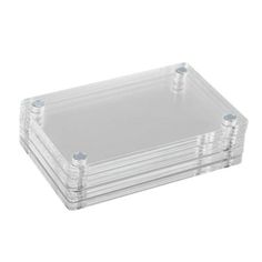 three clear plastic trays stacked on top of each other with screws in the middle