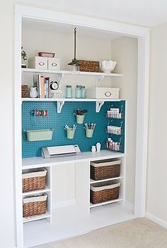 a room with some shelves and baskets on the wall next to each other in it