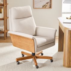 an office chair sitting on top of a white rug next to a desk with a lamp