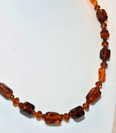 A beautiful amber colored specialty glass beaded necklace.  A mixture of brown ambercolored barrel & oval painted glass beads,  golden amber colored faceted glass & golden amber colored crystal beads.   Made with a sterling silver spring ring clasp with a adjustable chain catch, necklace is adjustable from 19-22 inches.  Matching earrings are made on sterling silver sheppard hooks & have a 1.75" drop.      This is a really pretty set...my pictures do not show this well.  IMPORTANT TO NOTE:  I DO NOT MASS PRODUCE!  Most pieces are a 1 or 2 of a kind.    THIS IS NOT COSTUME JEWELRY.   You will not be disappointed with my designs.   I make all of my beaded jewelry with good quality materials...genuine semi-precious gemstones, Swarovski Crystals, Sterling Silver, Specialty glass.  Most pieces Brown Glass Beads For Jewelry Making, Vintage Amber Beads For Gifts, Amber Oval Beads Single Strand Necklace, Amber Single Strand Necklace With Oval Beads, Amber Beaded Jewelry For Formal Occasions, Handmade Baltic Amber Necklace In Brown, Brown Faceted Jewelry Gift, Handmade Brown Baltic Amber Necklace, Formal Amber Beaded Jewelry